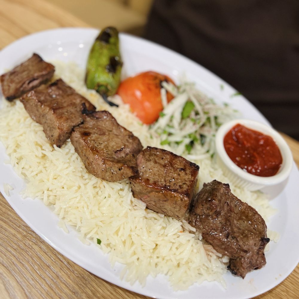 Beef kabob plate at Sierra Grill House with rice and grilled vegetables